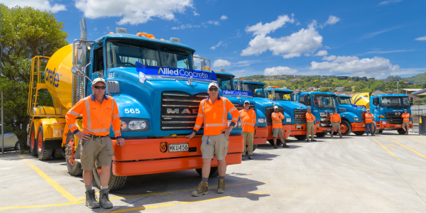 Allied Concrete staff proudly standing in front of their fleet